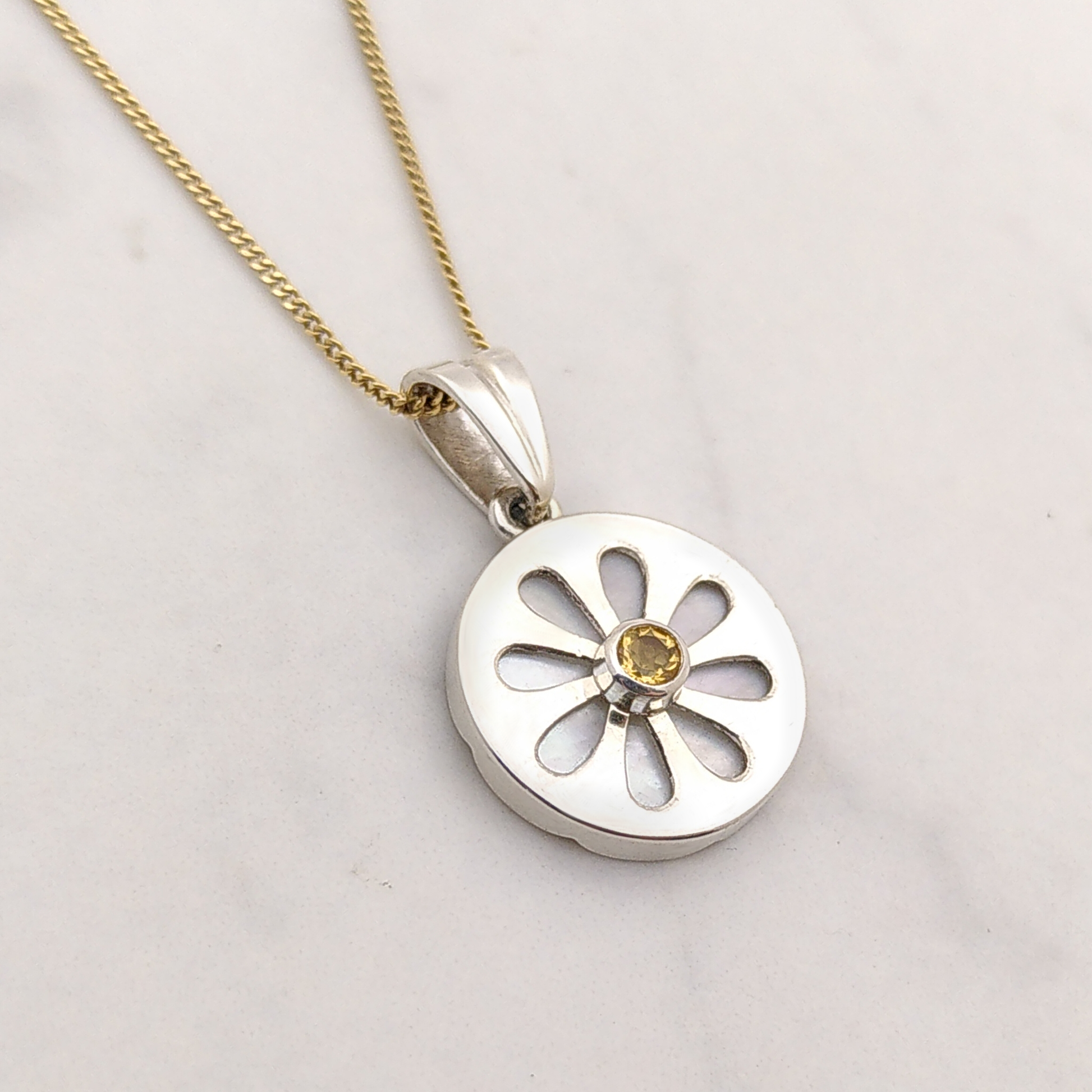 This picture is another view of the Marguerite pendant, showing the front and the side of the pendant at the same time.