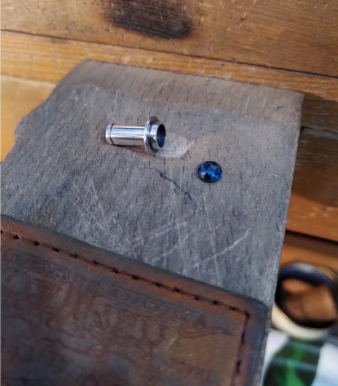 An earstudd made of sterling silver and a london blue topaz in the making. Made by hand by CASEZ Jewellery.